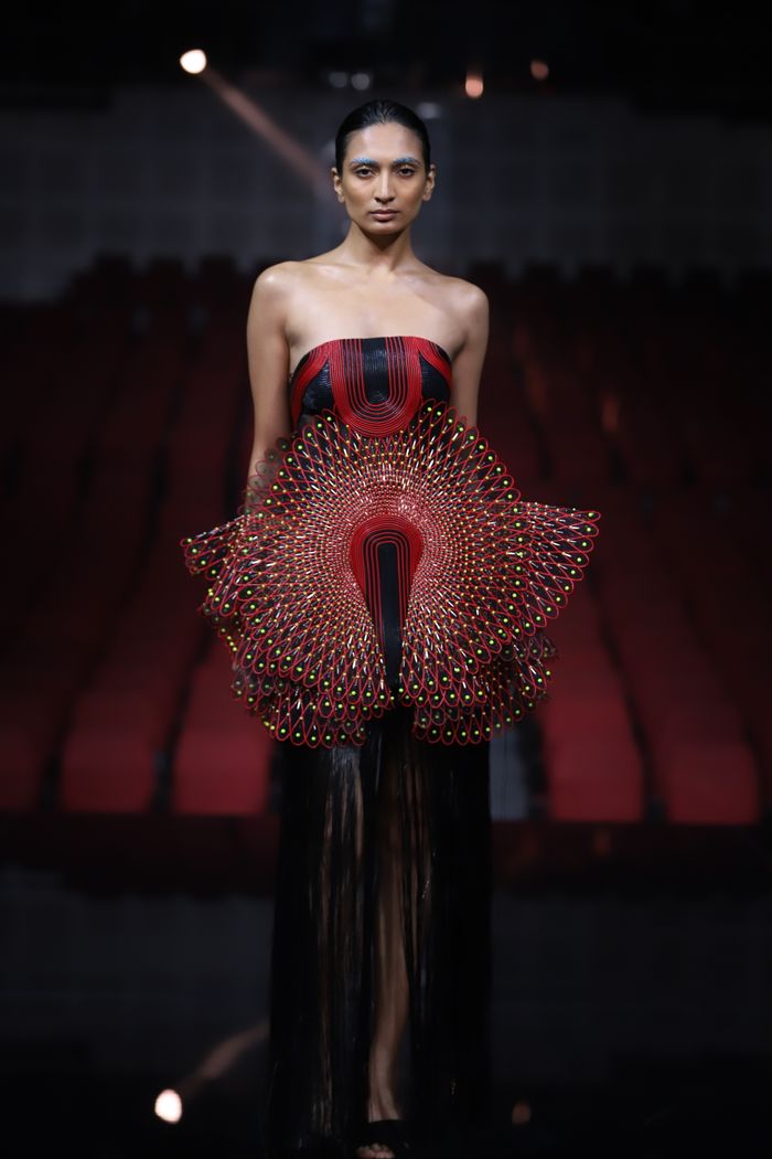 contact-img Stylish model showcasing avant-garde fashion on a runway in New Delhi.