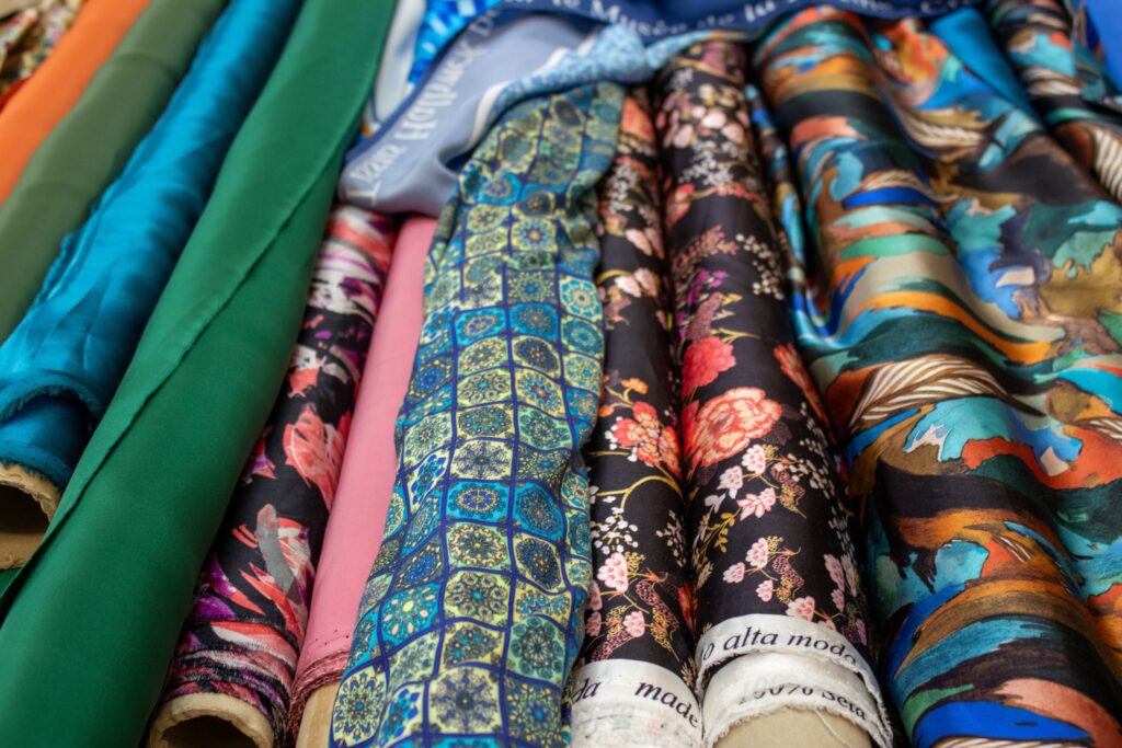 Journal Vibrant selection of patterned fabric rolls showcasing diverse textile designs.